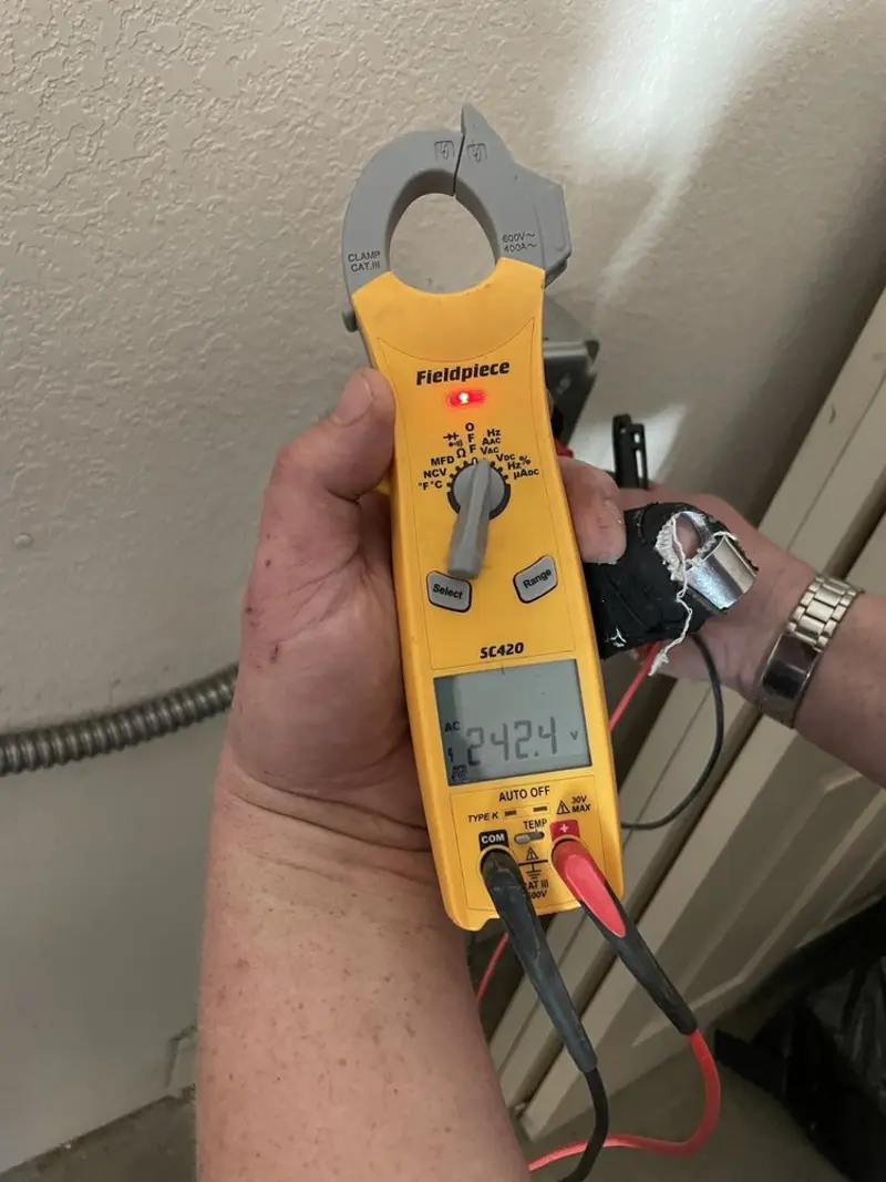 Voltage testing with clamp meter during Outlet Installation in Revere
